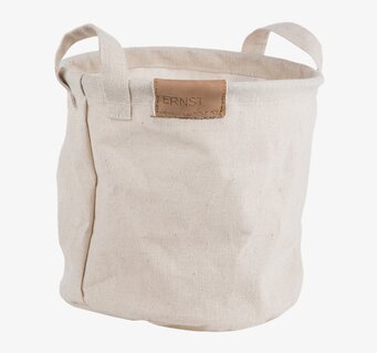 Bild på rund tygförvaring med handtag och läderdetalj