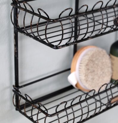 Bild av elegant antiksvart metallhylla med detaljer