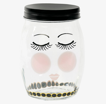 Bild av stilren glasburk med ansiktsmotiv och mönster