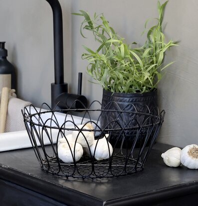 Bild av stilren köksinredning med svart trådkorg
