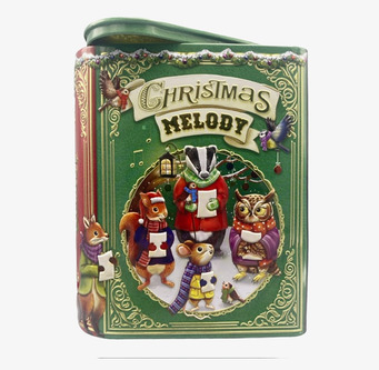 Bild av färgglad julplåtburk med djur och guldiga detaljer