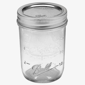 Bild av exklusiv plåtburk i klart glas och metallock