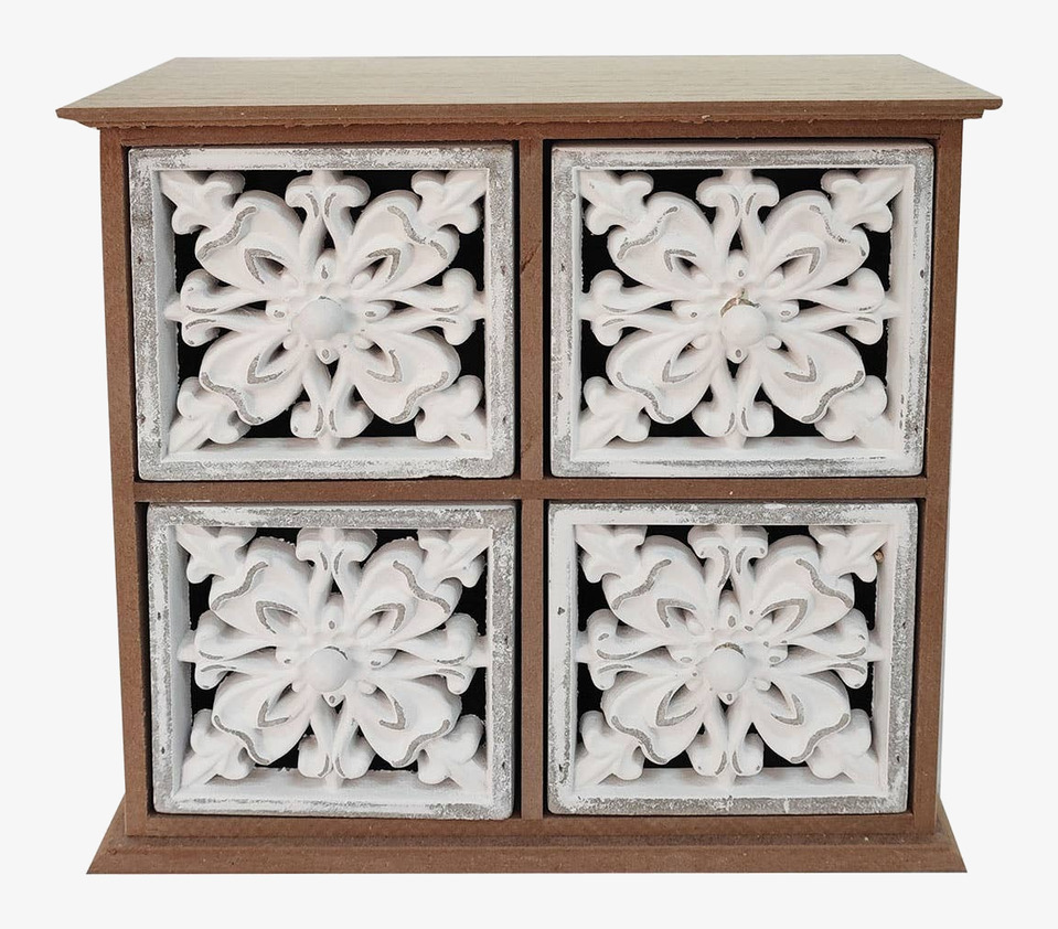 Bild av träskåp med lådor och blommigt mönster i vit dekor