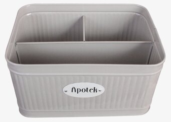 Bild på rektangulär beige plåtburk med fyra fack och skylt