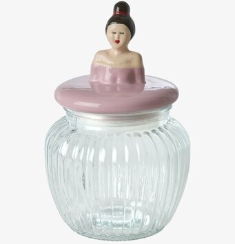 Bild på glasburk med rosa keramiklock och kvinnodekoration