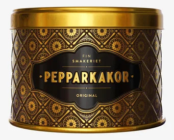 Foto: Mörkbrun plåtburk med guldmönster och etikett