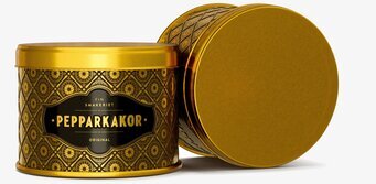 Foto: Rund guldtonad plåtburk med mönsterlocket