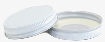 Bild av vita lock med räfflad kant och gummipackning