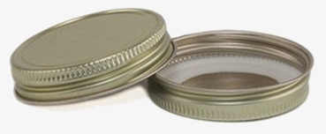 Bild av guldtonat metallock för burkar med elegant design