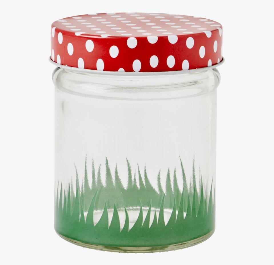 Bild av glasburk med rött prickigt lock och grön bas